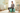 Pregnant woman sitting on Trideer teal birthing ball in a cozy nursery