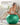 Woman performing a forearm plank on a green Trideer exercise ball at home.