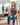 Woman seated on a chair with a small green Trideer physical therapy ball between her knees.