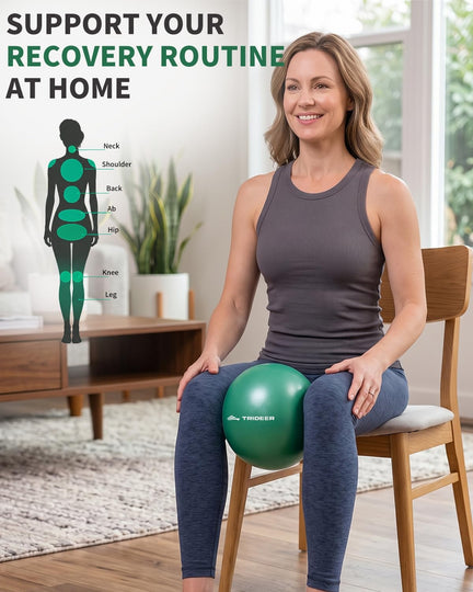 Woman seated on a chair with a small green Trideer physical therapy ball between her knees.