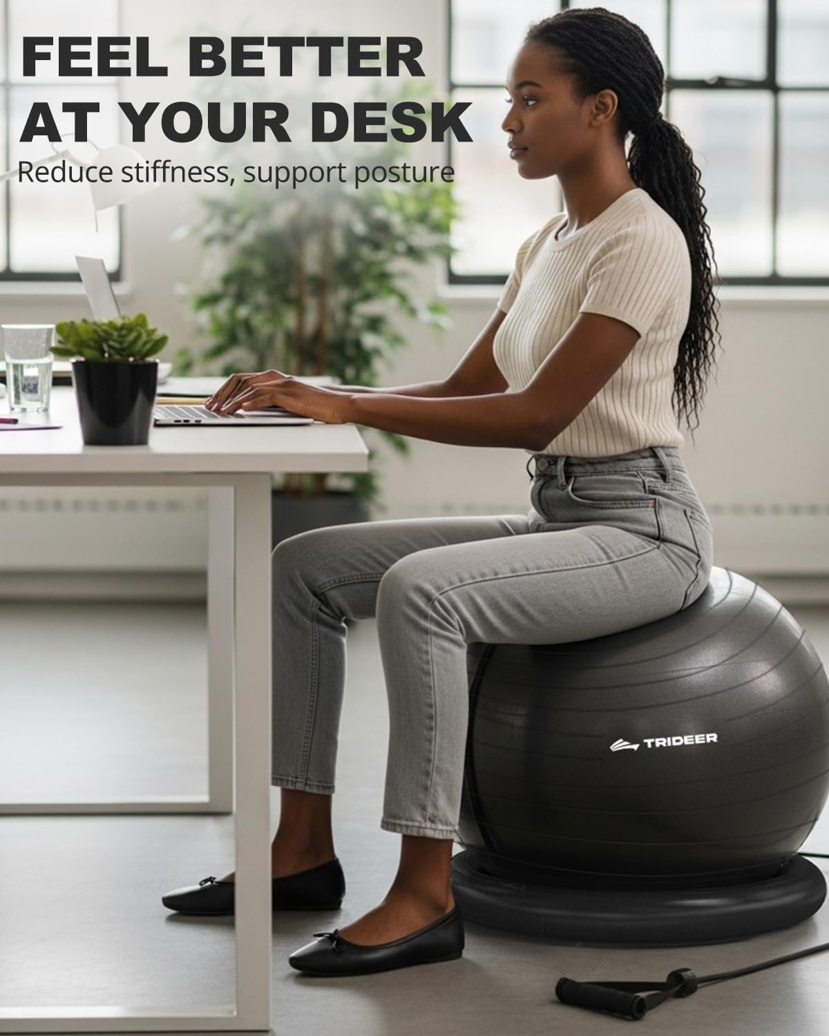 Woman working on a laptop while seated on a black Trideer ball chair with ring base