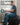 Man working at a desk while seated on a black Trideer exercise ball chair