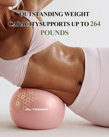 Woman lying on her side with a pink Trideer mini Pilates ball supporting her waist