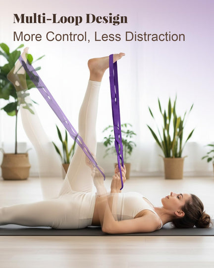 Woman lying on a yoga mat using a purple multi-loop strap to stretch one raised leg.