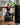 Woman seated on a Trideer ball chair with arms extended using resistance bands at home
