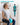 Woman seated on a chair with a turquoise Trideer mini Pilates ball between her knees