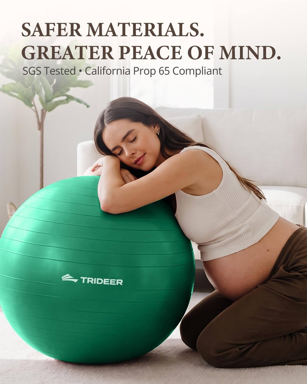 Pregnant woman kneeling and resting her head and arms on a green Trideer exercise ball.
