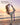 Woman balancing on one leg at the beach, using a purple stretching strap to hold her raised back foot.
