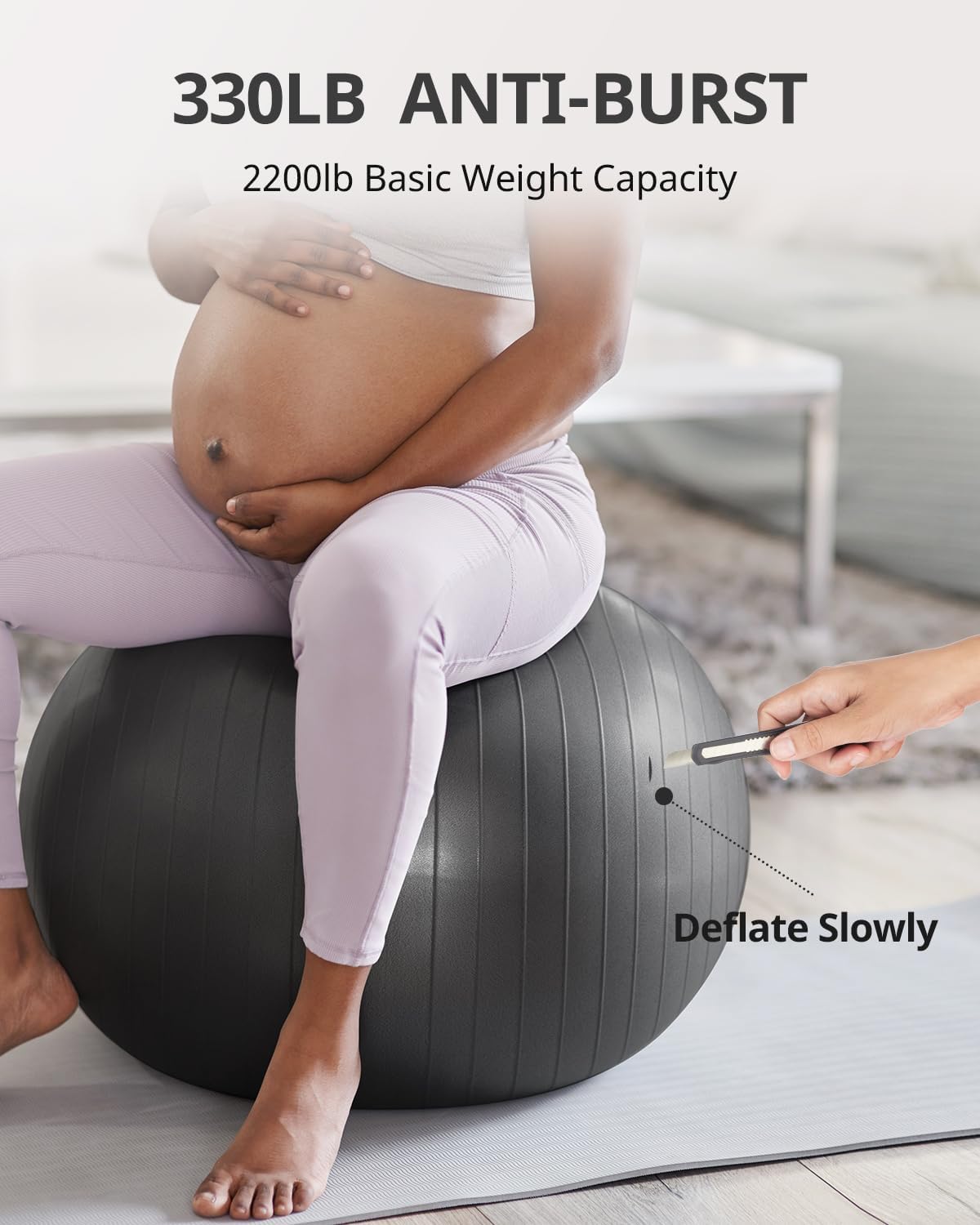 Woman using 65cm exercise ball for pregnancy workout