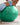 Woman leaning back on a green Trideer exercise ball, with a graphic highlighting its textured surface.