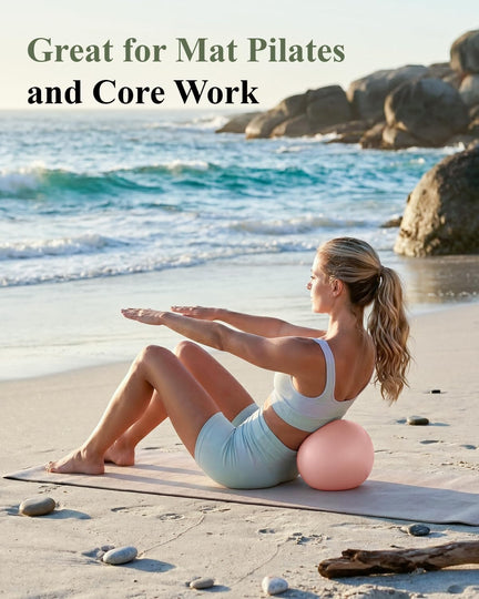 Woman doing mat Pilates on a beach with a pink mini exercise ball supporting her lower back