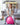 Smiling girl sitting on a pink Trideer kids ball chair during playtime at home.