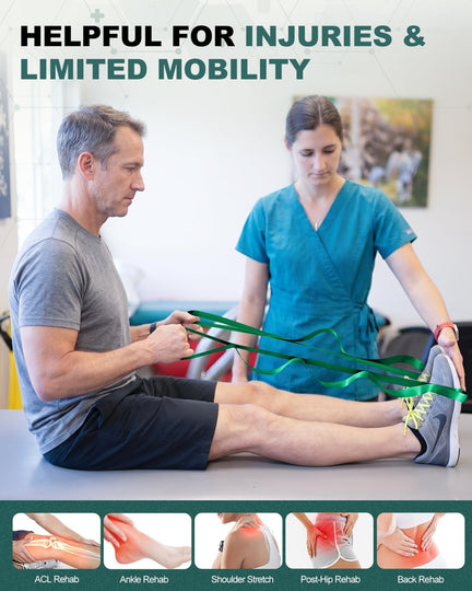 Man seated on a treatment table using a green stretching strap around his feet with assistance.