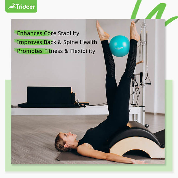 Woman using 9 inch pilates ball for core training and yoga exercises
